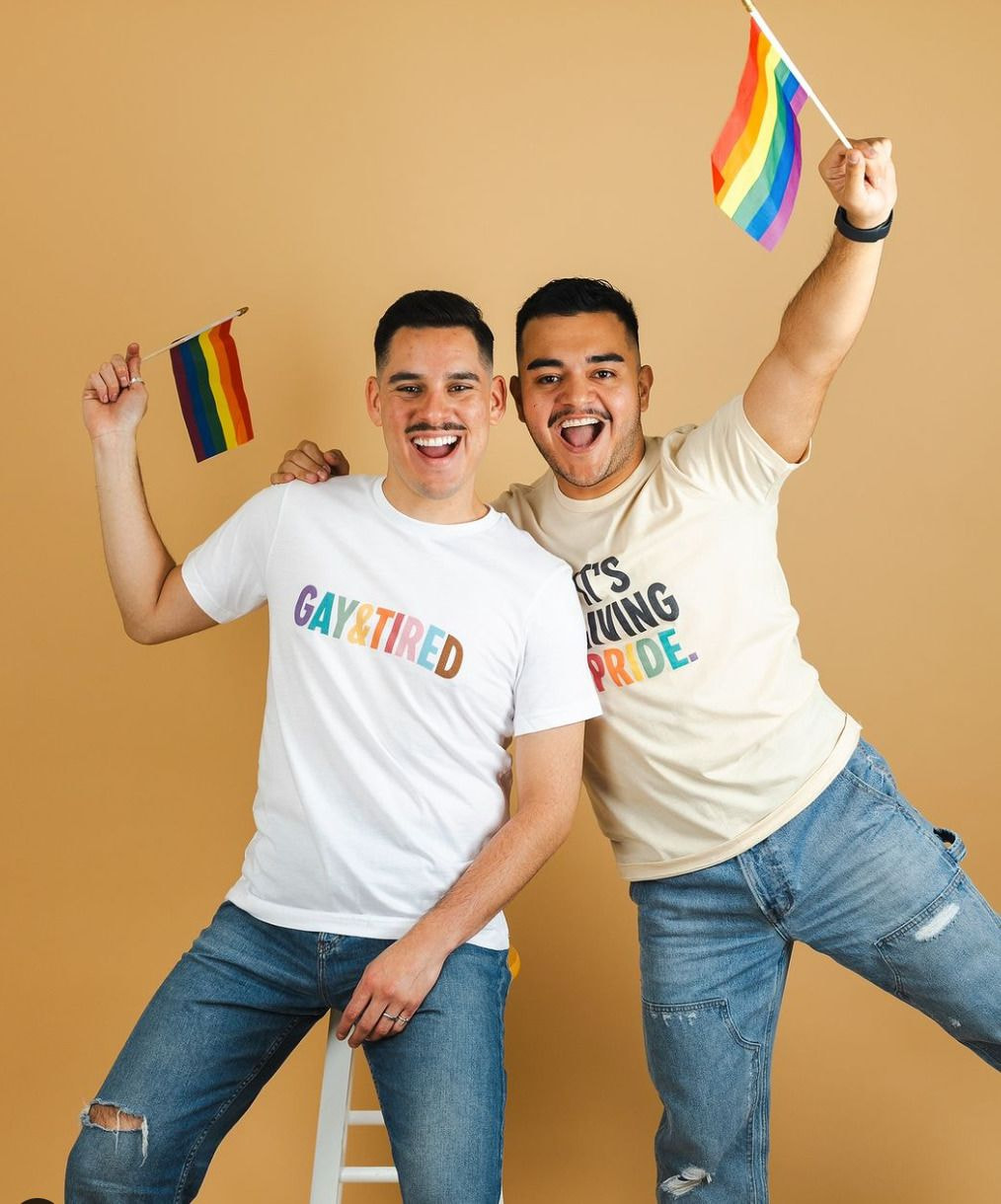 two men holding flags and smiling